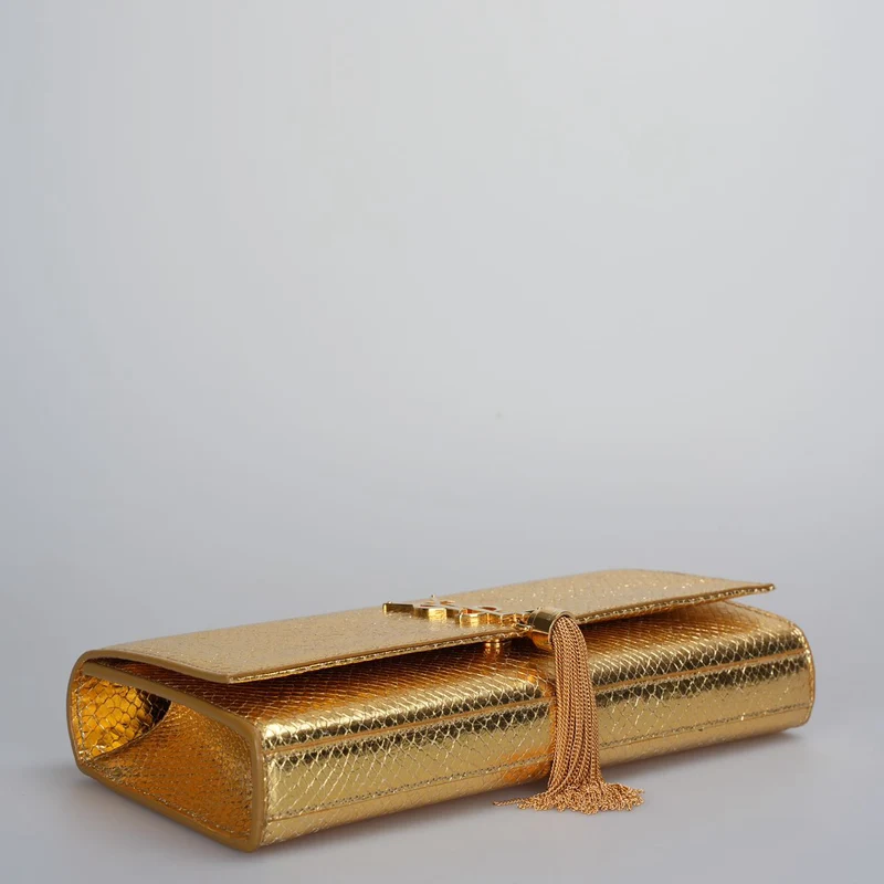 Saint Laurent – ​​Klassische Clutch aus goldmetallicfarbenem Kalbsleder mit geprägtem Monogramm und Quaste